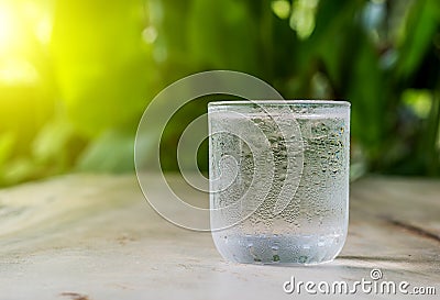 Glass cold water on wooden floor. Stock Photo