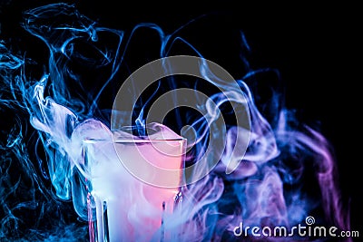 A glass with colorful smoke Stock Photo