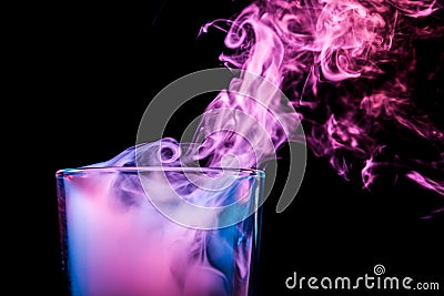 A glass with colorful smoke Stock Photo