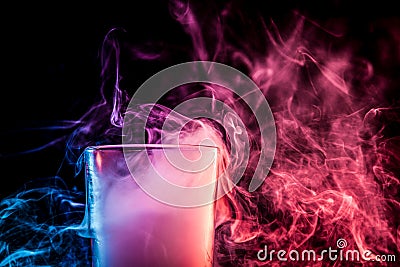 A glass with colorful smoke Stock Photo