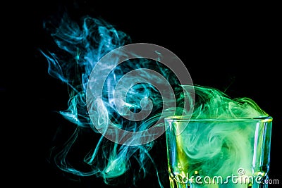 A glass with colorful smoke Stock Photo