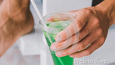 A glass of cool soda in men`s hands close-up. Chill concept Stock Photo