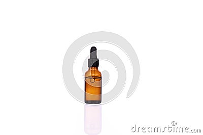 Glass cosmetic brown bottle with pipette and clear transparent liquid Stock Photo