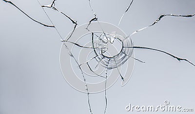 glass crack after window destruction on soft blue background Stock Photo