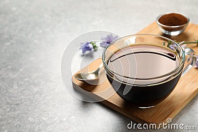 Glass cup of delicious chicory drink on light grey table, closeup. Space for text Stock Photo