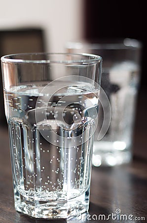 Glass cup with mineral water on the table Stock Photo