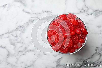 Glass of delicious chewing candies on marble table Stock Photo