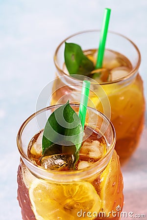 Glass of Delicious Iced Tea with Lemon on Light Blue Background Vertical Above Stock Photo