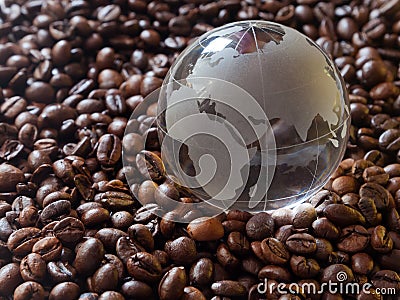 Glass earth globe Africa and Asia in center closeup among coffee beans background Stock Photo