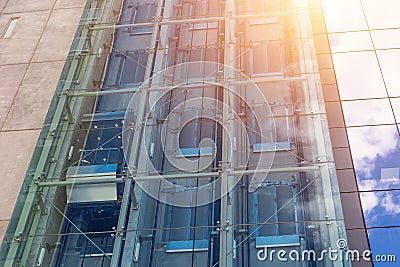 Glass elevators outside the skyscraper building, business architecture Stock Photo