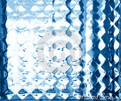 Glass embossed pattern in blue tones. Glass relief. Stock Photo