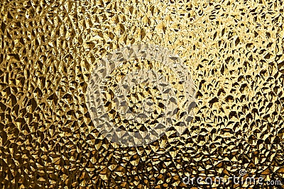 Glass with embossed wave pattern. Glass yellow or gold color. Stock Photo