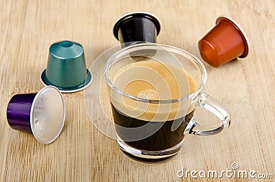 Glass of espresso with nespresso capsules Stock Photo