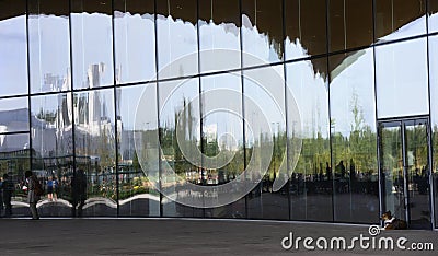 Glass facade of the building of Central Library Oodi in Helsinki, Finland, reflections and a dog Editorial Stock Photo