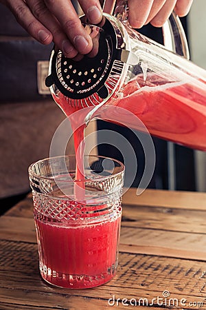 Pouring grapefruit juice in the glass. Stock Photo