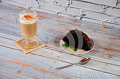 A glass of fresh latte and a piece of chocolate muffin. Close up shot Stock Photo