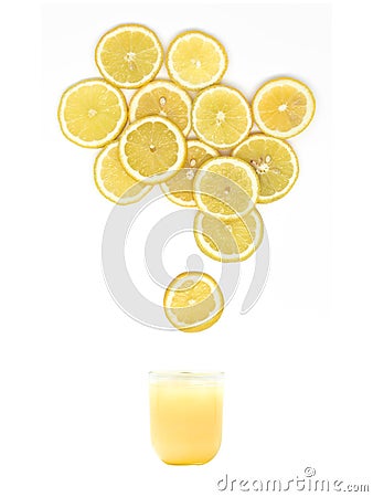 Glass with fresh lemon juice is standing under many lemon slices on white background Stock Photo