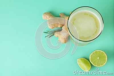 Glass of ginger beer and ingredients on mint background Stock Photo