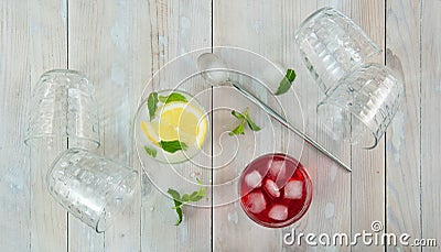 Glass glasses seen from above, some empty overturned others with iced red and yellow cocktails Stock Photo