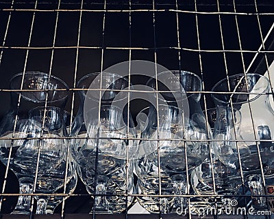 glass goblets behind a wire fence. Stock Photo