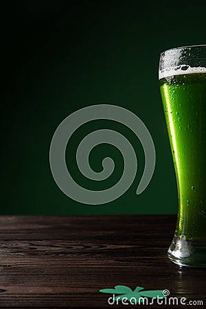 glass of green beer with shamrock on table st patricks Stock Photo