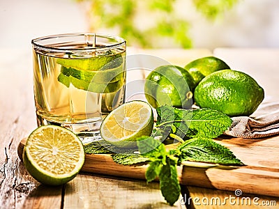 Glass with green lime drink and mint on napkin. Stock Photo