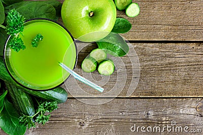 Glass of green vegetable juice, downward view on rustic wood Stock Photo