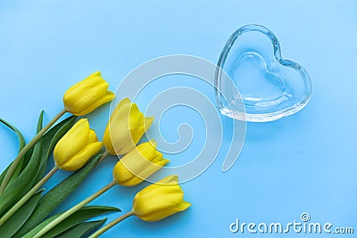 Glass heart and classic tulips on a classic blu background, fragile love background, valentines day concept, Pantone 2020 Stock Photo