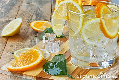 Glass homemade lemonade, ice, orange, lemon closeup Stock Photo