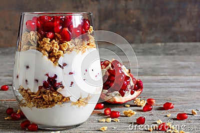 Glass of homemade yogurt parfait with granola and pomegranate fr Stock Photo