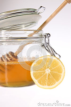 Glass honey with sticks Stock Photo