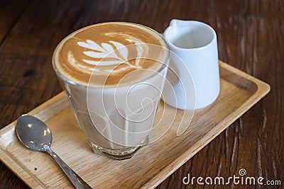 A glass of hot Piccolo latte coffee on wood tray Stock Photo