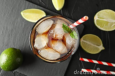 Glass with ice cola and tubule on black background Stock Photo