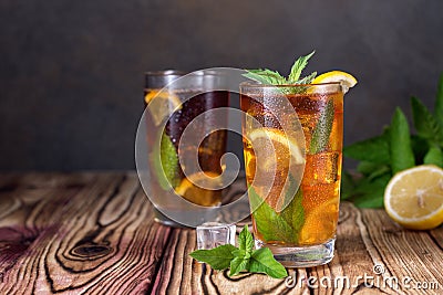 Glass of iced tea with mint and lemon. Cold drink. Rustic style Stock Photo