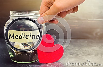 Glass jar with coins and the inscription `Medicine`. The concept of family medicine insurance, healthcare. Medical expenses. Distr Stock Photo