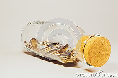 Glass jar with cork stopper and filled with international coins from various countries. finance storage concept Stock Photo