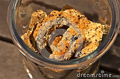 Glass jar filled with homemade rusks on a wooden surface Stock Photo