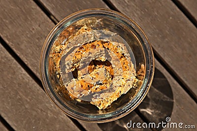 Glass jar filled with homemade rusks on a wooden surface Stock Photo