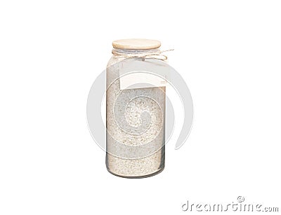 a glass jar filled with rise with a white label in it is displayed Stock Photo