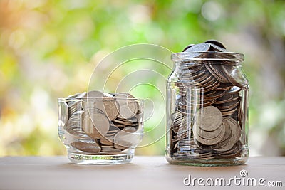 A glass jar full coins with copy space for text, saving money concept, home, loan, education, step for future Stock Photo