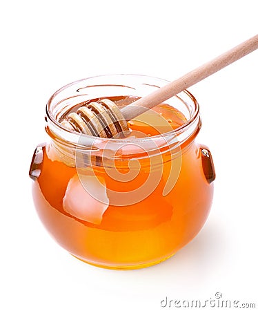 Glass jar of honey with wooden drizzler Stock Photo