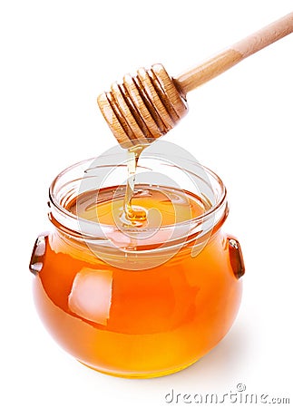 Glass jar of honey with wooden drizzler Stock Photo