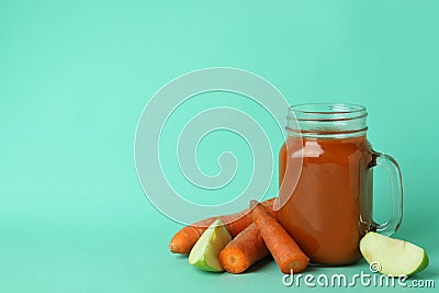 Glass jar of juice and ingredients on mint background Stock Photo