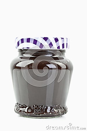 Glass jar of plum jam on white background Stock Photo