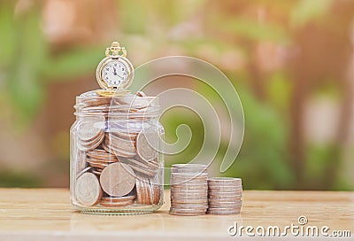 Glass jar with retro clock for time to money saving for retirement concept Stock Photo