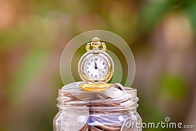 Glass jar with retro clock for time to money saving for retirement concept Stock Photo