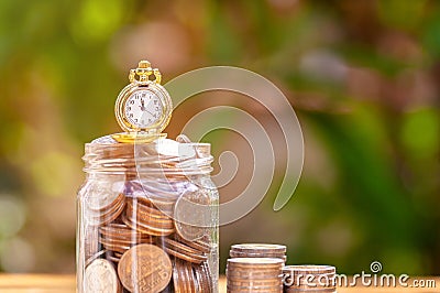 Glass jar with retro clock for time to money saving for retirement concept Stock Photo