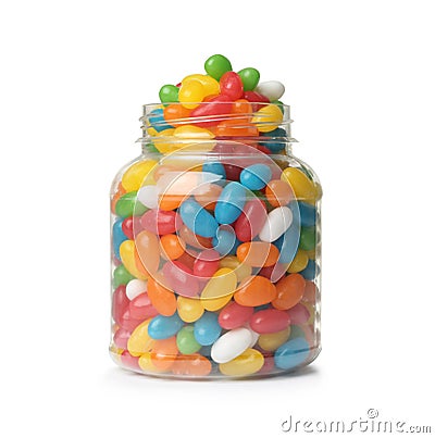 Glass jar of tasty bright jelly beans on white Stock Photo