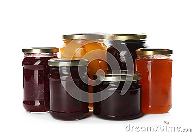 Glass jars with different pickled fruits and jams on background Stock Photo