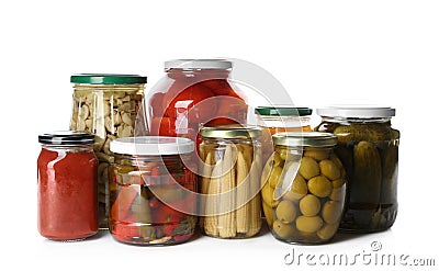 Glass jars with different pickled vegetables and mushrooms on background Stock Photo